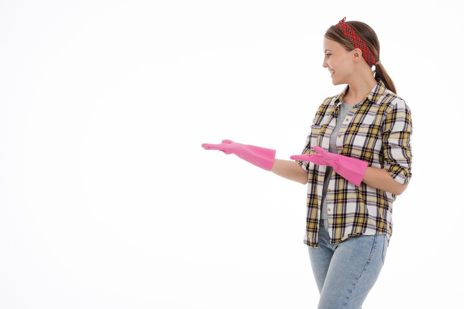 Smiling professional house cleaner ready to provide maid service